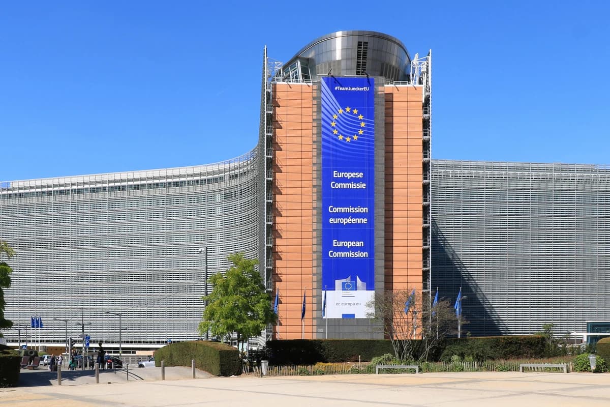 Фасад здания Berlaymont в Брюсселе с вертикальным баннером Европейской комиссии.
